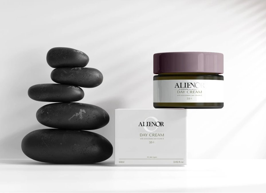 Alienor Day Cream packaging design showing minimalist white box and glass jar with purple lid, alongside black zen stones